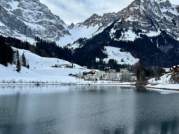 snow covered mountains in winter. Lake in Engelberg, Switzerland.