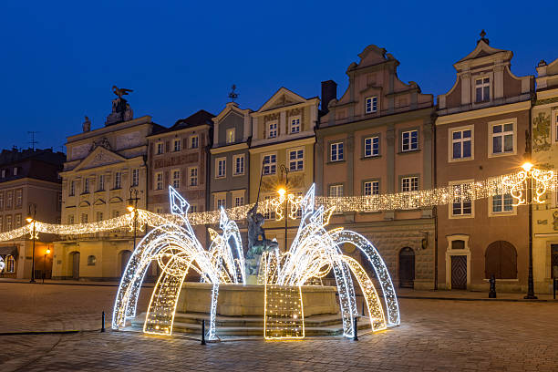 Holiday lights and fountain on the historic square in Poznan.