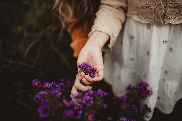 Mother and daughter picking wildflowers with copy space