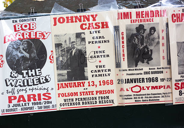 Paris, France - October 19, 2025: A row of old musical concert posters at an outdoor antiquarian bookseller (bouquiniste) along the banks of the Seine.