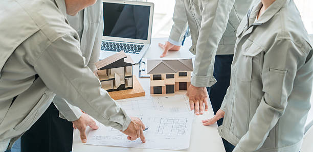 Architects, designers, workers, and engineers meeting at construction companies, house manufacturers, architectural firms, and builders to discuss houses