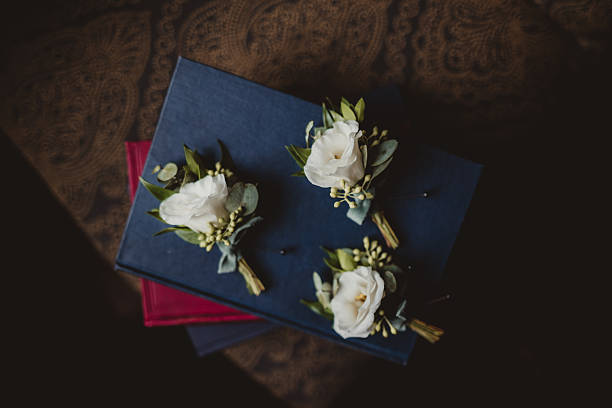 White rose boutonniere for groom at wedding