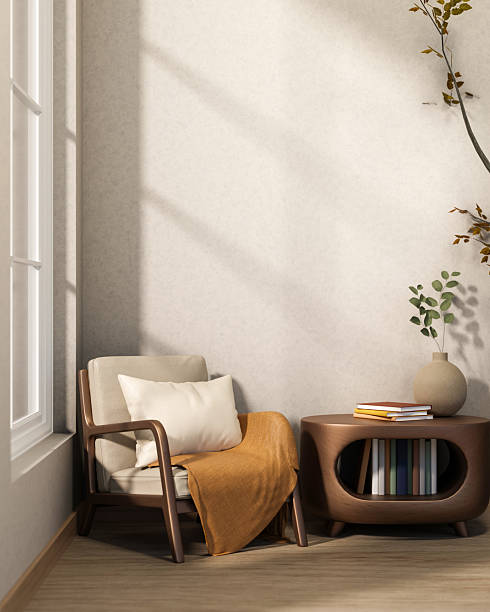 Wooden armchair and bookcase table on parquet floor with sunlight through window in white wall room.