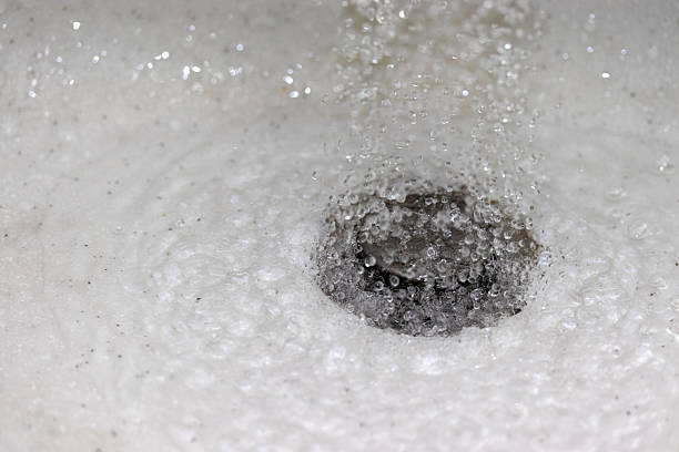Water splashing down the sink drain