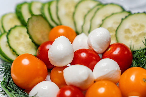 Vegetable plate with tomatoes and cucumbers and mini round mozzarella