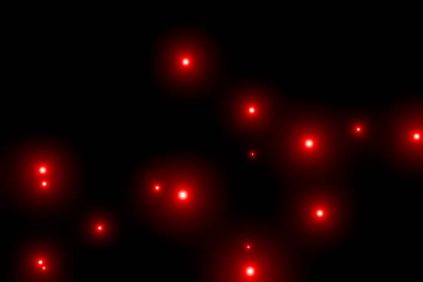 Many red particles floating on a black background