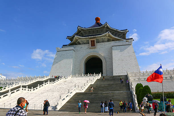 Taipei City, Taiwan - October 30, 2023: Chiang Kai-shek Memorial Hall and tourists standing against the blue sky
