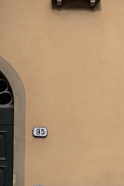 istock Door with number 95 on an old building wall 2258611306