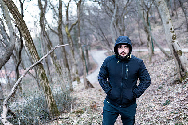 The portrait of a man walking alone in the forest.