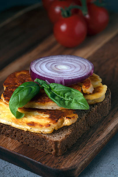 Grilled halloumi on rye bread with red onion ring and basil