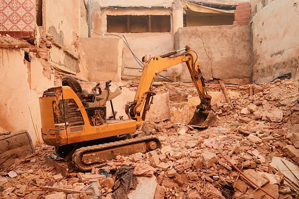 Deconstruction site with close-up of claw of excavator tearing down apartment building at Swiss city of Zürich on a late summer morning. Photo taken September 9th, 2025, Zurich Schwamendingen, Switzerland.
