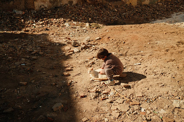 a young cute homeless girl got a used toy by a charity foundation
