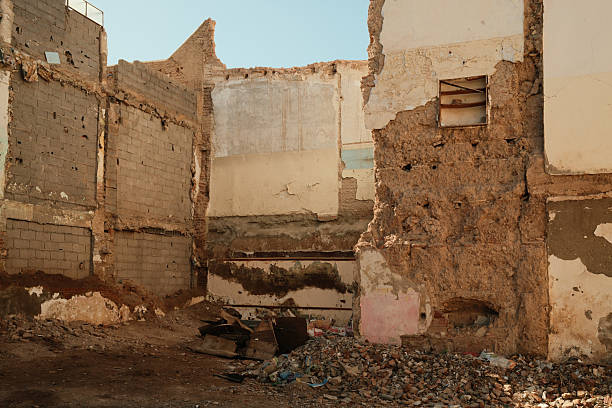 Eroded walls and fallen structures inside a demolished building in Morocco, highlighting urban decay, abandonment, and the passage of time