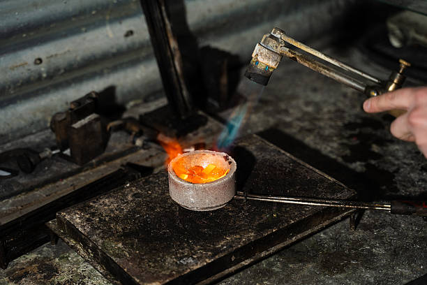 Jeweler manual gold melting process with torch in crucible
