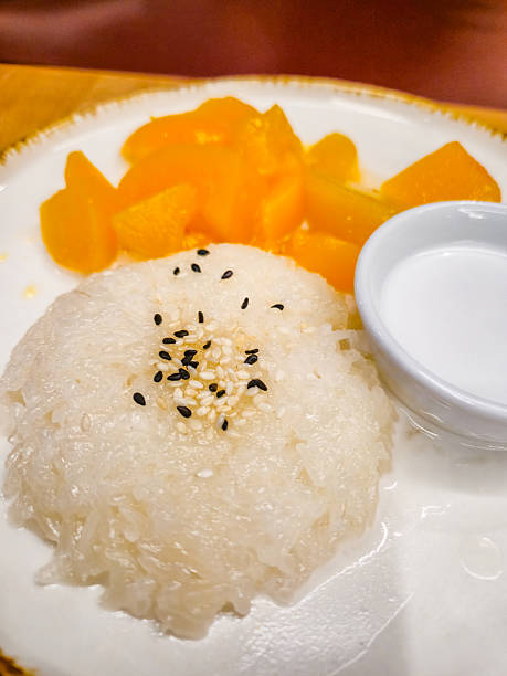Sticky Sweet Rice And Peaches On The Plate In A Restaurant