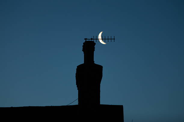 The moon next to the chimney