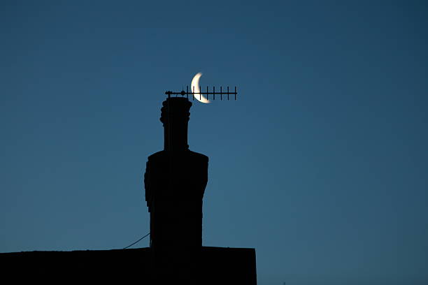 The moon next to the chimney