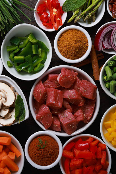 Preparing Beef Stew with herbs spices and vegetables