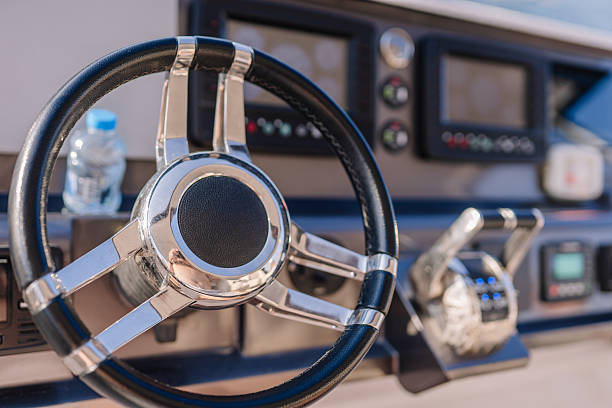 Steering wheel and control panel inside the cabin of a yacht speedboat.