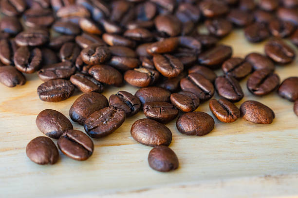 High-quality roasted coffee beans with a rich oily texture and deep brown color, perfect for coffee shop branding and cafe menus.
