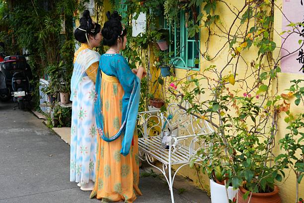Costumed women pose for photos in Shawan ancient town (Shawanzhen) in Guangzhou city in Guangdong region of China.