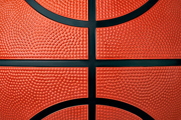 istock Pattern of orange rubber textured basketball ball background 2258636357