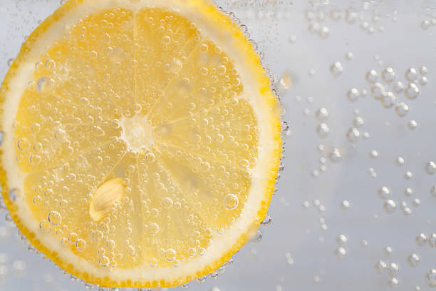 istock Close-up of a lemon with bubbles floating in water 2258642713