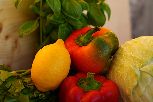 Vegetables including red pepper, lemon, white cabbage, and infected celery leaves affected by the fungal disease Cercosporin leaf spot.
