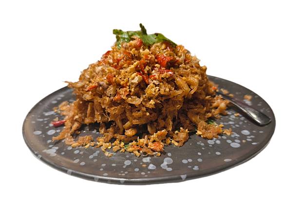 A mountain of crispy, deep-fried goodness,small fish and shrimp,tossed with a ton of fried garlic and bright red chilies. It's topped with a bit of cilantro for a pop of green.