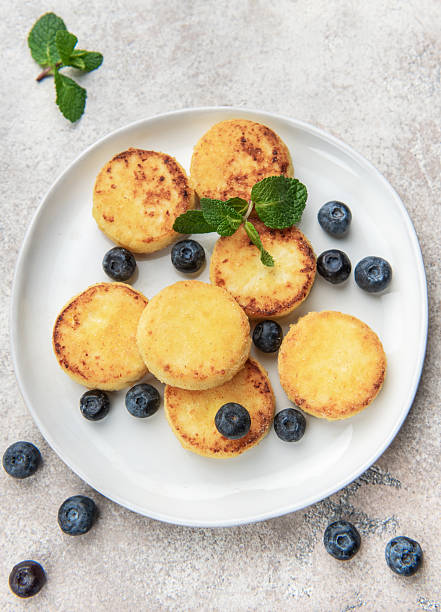 Homemade syrniki cottage cheese pancakes with blueberries and mint