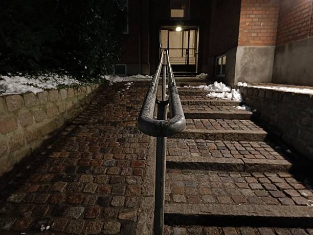 cobblestone stairs and ramp with railing at night