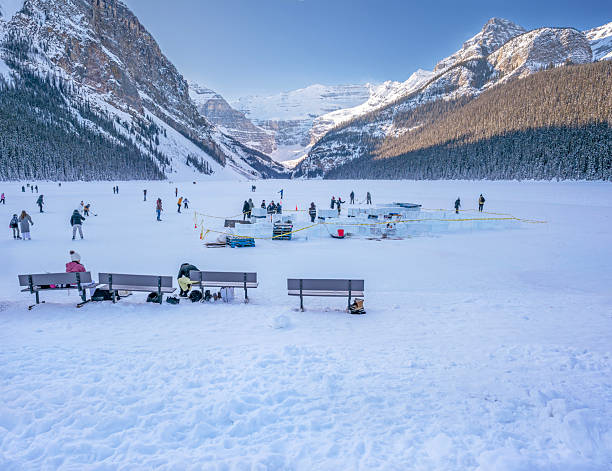Unrecognizable people gather on frozen Lake Louise in Banff National Park, Canada