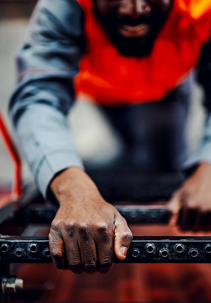 Close up of unrecognizable steel worker working with iron in a workshop.