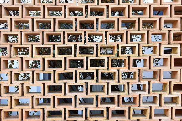 a brick lattice wall on a street