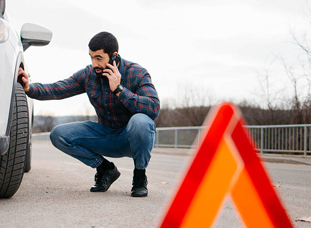 man on the road calling road assistance