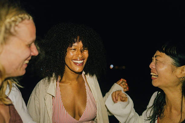 Group of multi-ethnic teenager friends celebrating a funny rooftop party