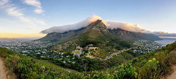wide elevated panoramic view from lions head on on Cape Town, table mountain and the Twelve Apostles  at sunset