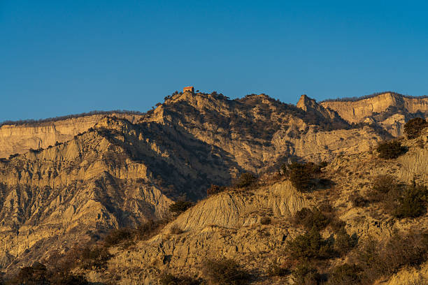 Dry mountain landscape with gentle slopes and open sky creating natural copy space. Suitable for environment and background use.