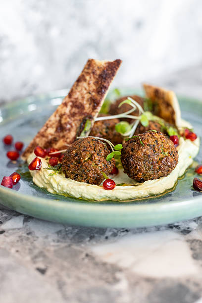 Fresh falafel with hummus dip and pomegranate served in gourmet restaurant in Middle East
