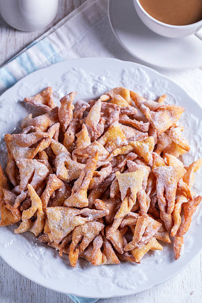 istock Traditional Maslenitsa dessert angel wings served with coffee on a light background. 2258691487