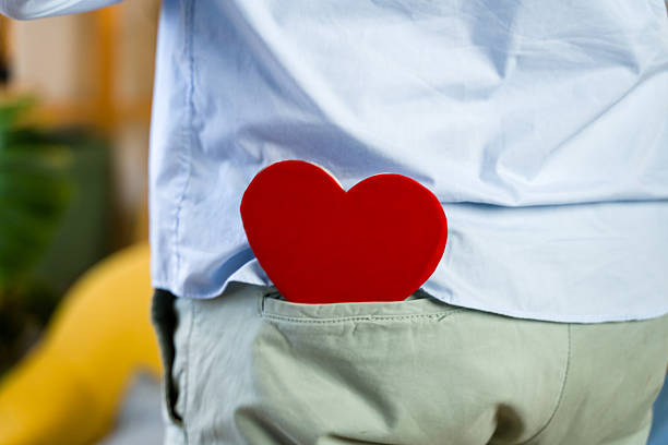 Person carrying a red heart in khaki pants back pocket