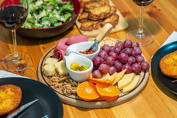 istock Charcuterie Board With Wine, Salad and Dinner Table Setting 2258707716