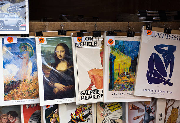Paris, France - October 19, 2025: Rows of vintage art posters on display and for sale at an outdoor antiquarian bookseller (bouquiniste) along the banks of the Seine.
