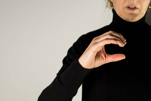 A hand curved into the shape of the letter C, showing the manual alphabet gesture used in deaf communication.
