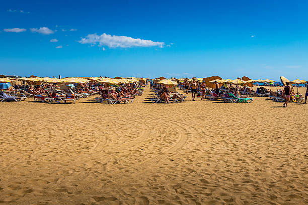 people relax at the beach by beautiful weather in Maspalomas at Grand Canary Island