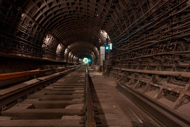 A view of a working subway tunnel. The train's tracks are laid on the floor. A contact rail, which supplies electricity, is mounted to the side.