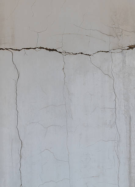 Grunge white concrete cement wall with crack
