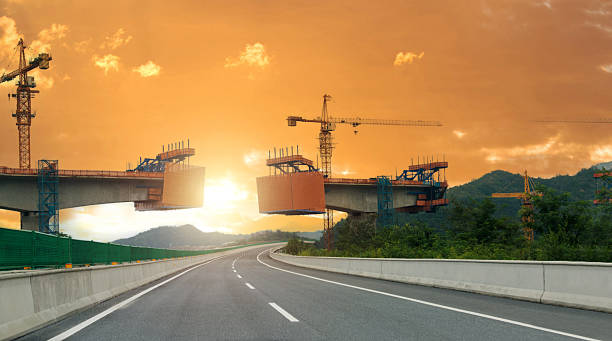 Sunset over highway bridge under construction on the mountain