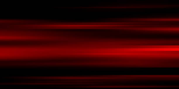 istock The effect of red light in fast motion on a black background. blurred abstract background with long exposure. neon light 2258736932