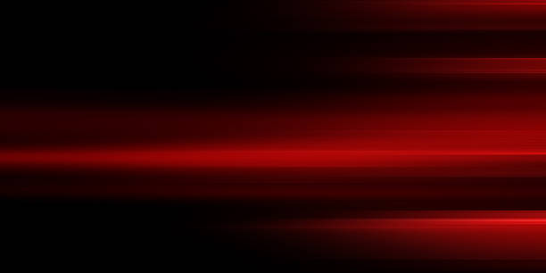 istock The effect of red light in fast motion on a black background. blurred abstract background with long exposure. neon light 2258736942